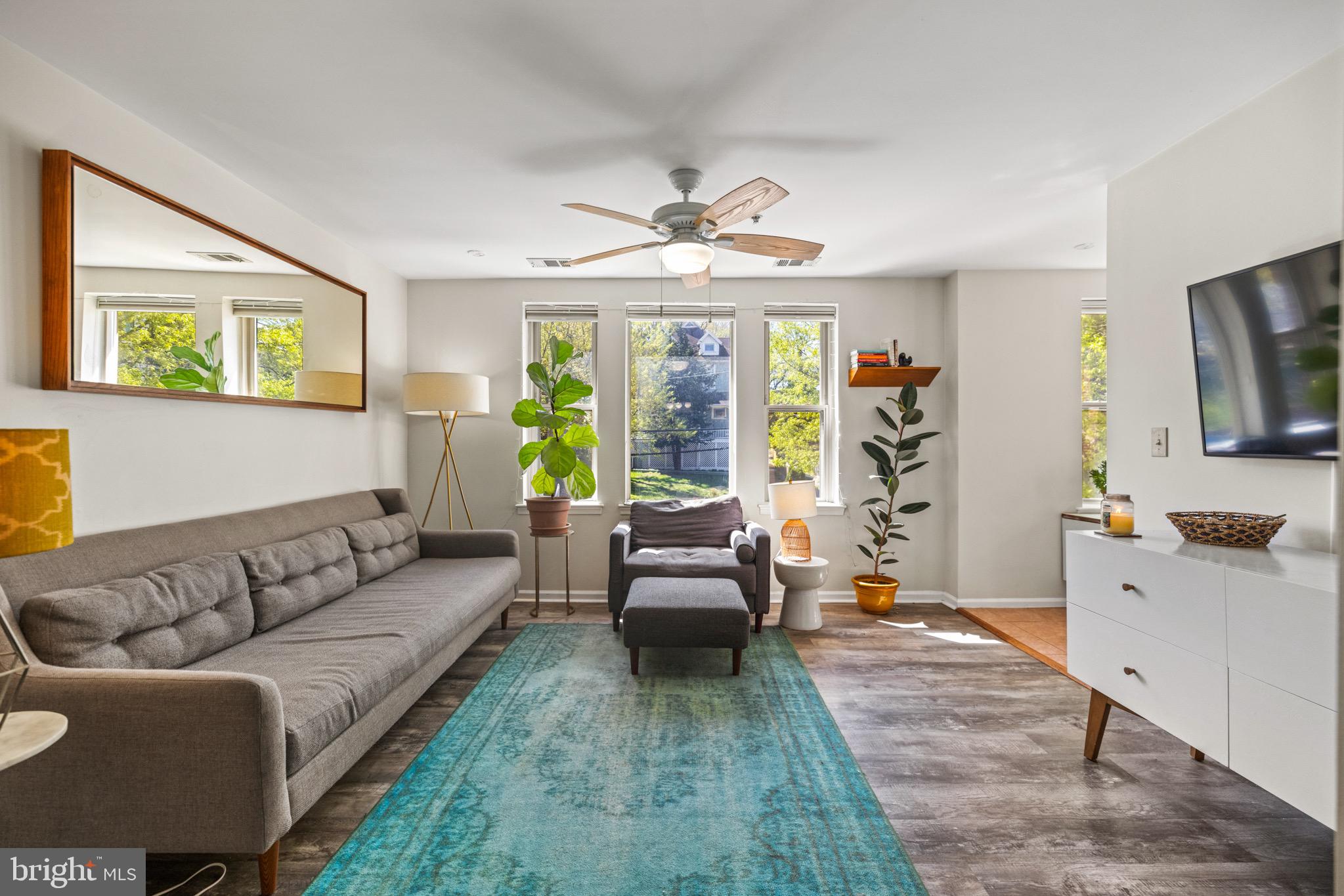 1210 Perry Street Northeast, Unit 201 Washington, DC 20017 - Photo 8 of 16 a living room with furniture and a flat screen tv