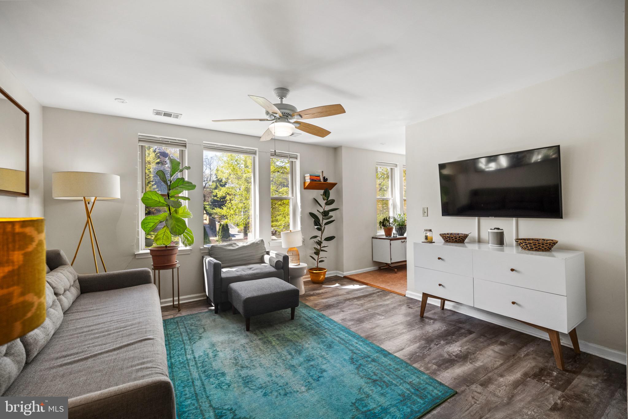 1210 Perry Street Northeast, Unit 201 Washington, DC 20017 - Photo 9 of 16 a living room with furniture and a flat screen tv
