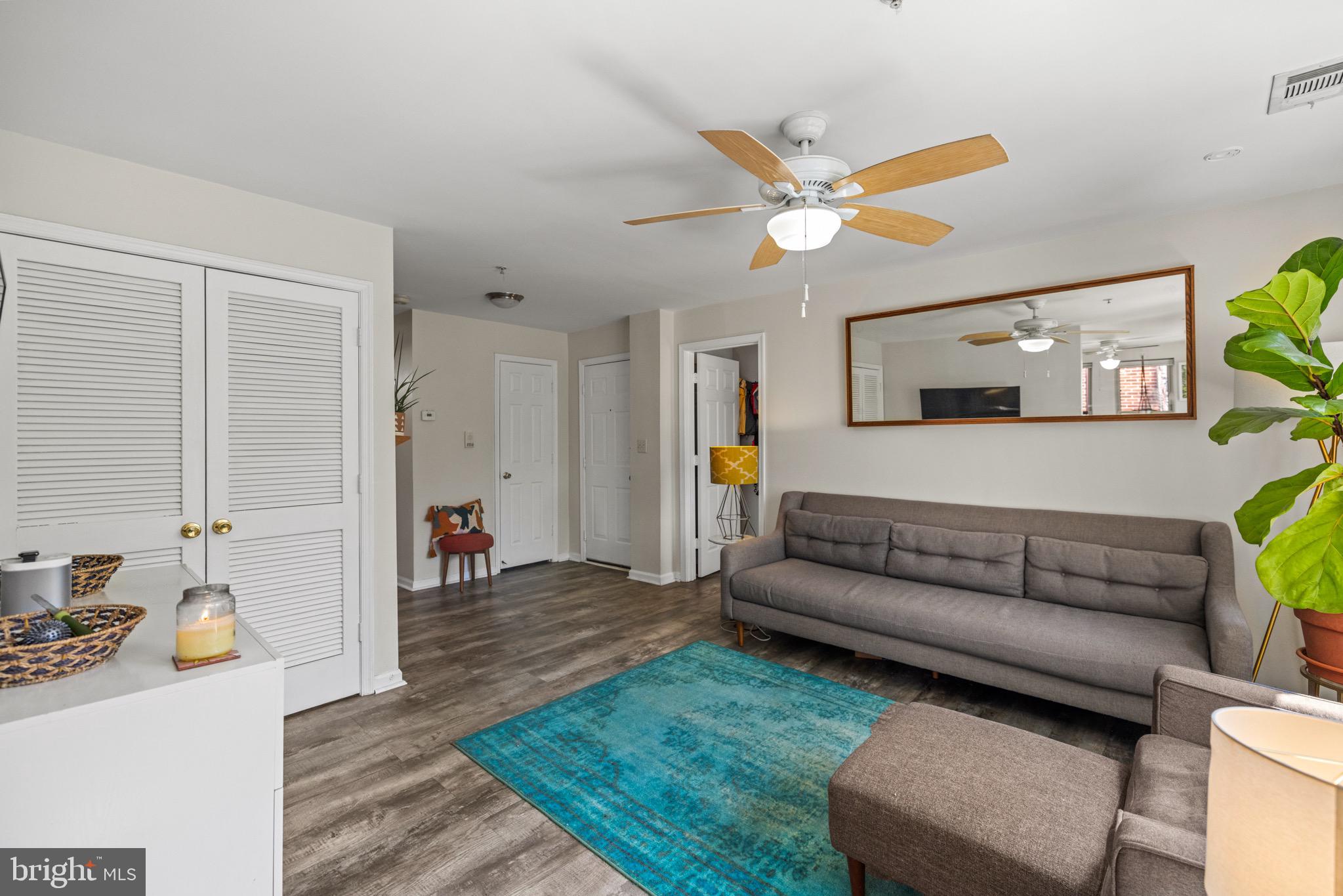 1210 Perry Street Northeast, Unit 201 Washington, DC 20017 - Photo 10 of 16 a living room with furniture and a chandelier