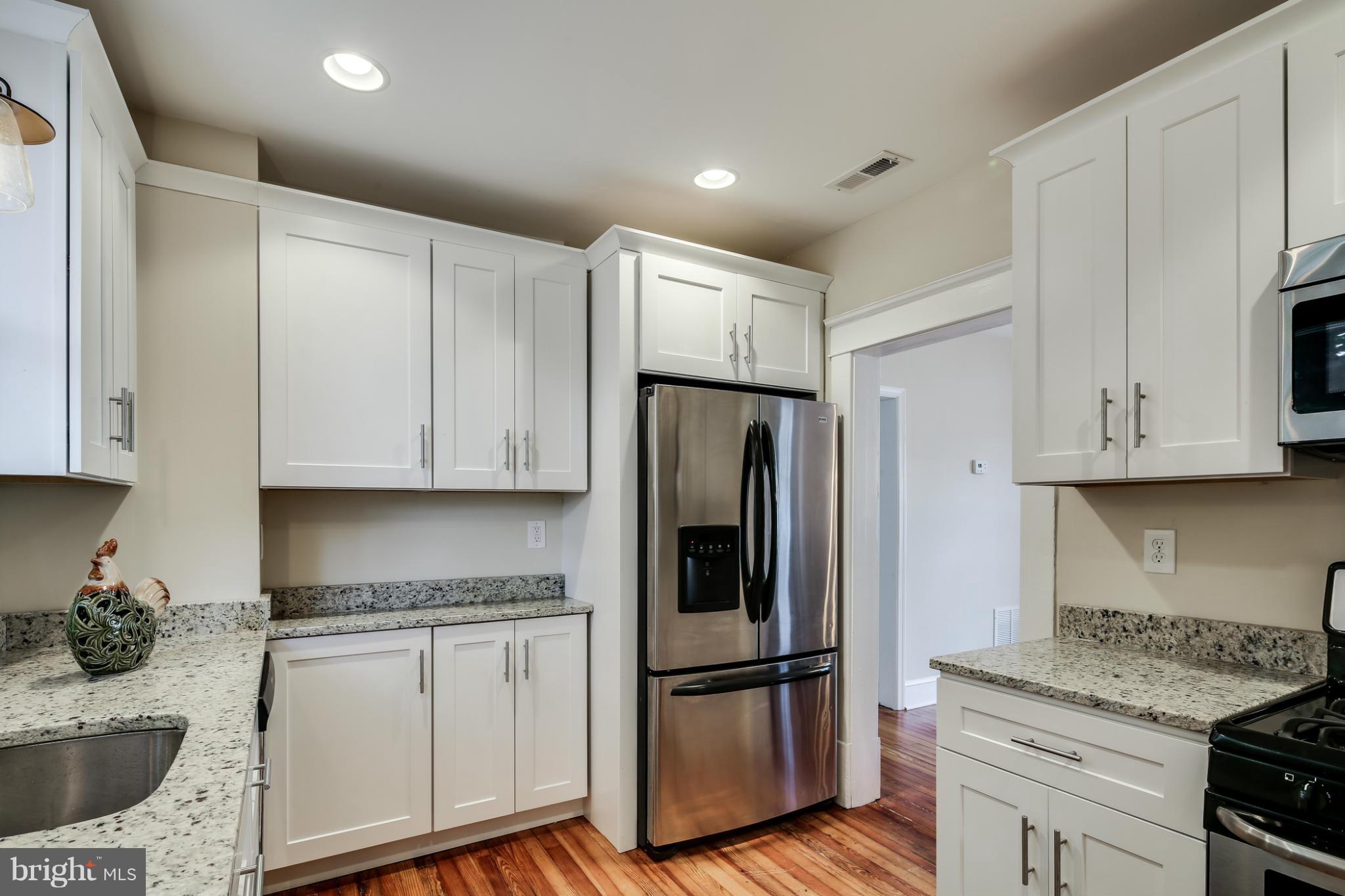 3202 Grace Road Baltimore, MD 21219 - Photo 11 of 29 a kitchen with white cabinets and stainless steel appliances