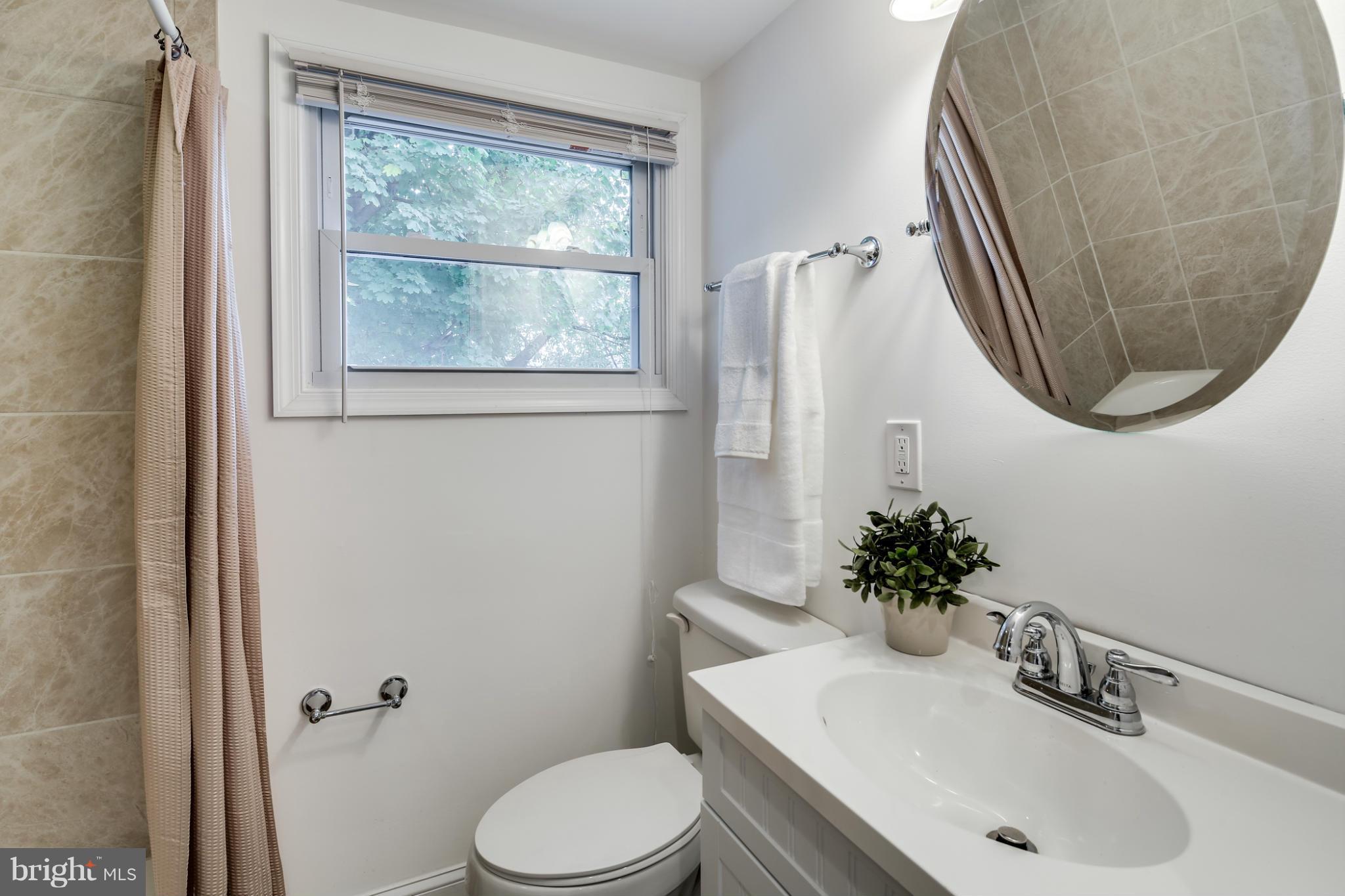 3202 Grace Road Baltimore, MD 21219 - Photo 12 of 29 a bathroom with a sink toilet and mirror