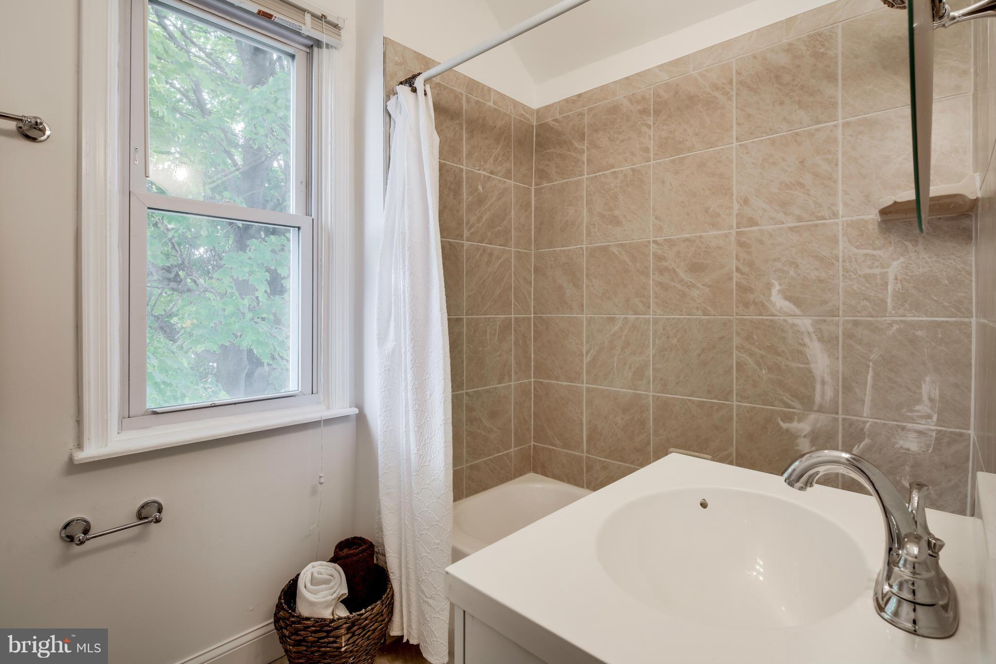 3202 Grace Road Baltimore, MD 21219 - Photo 13 of 29 a bathroom with a sink a toilet and shower