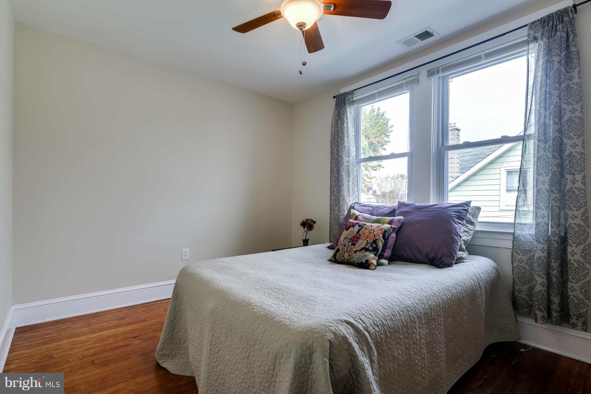 3202 Grace Road Baltimore, MD 21219 - Photo 16 of 29 a bedroom with a large bed and a chandelier