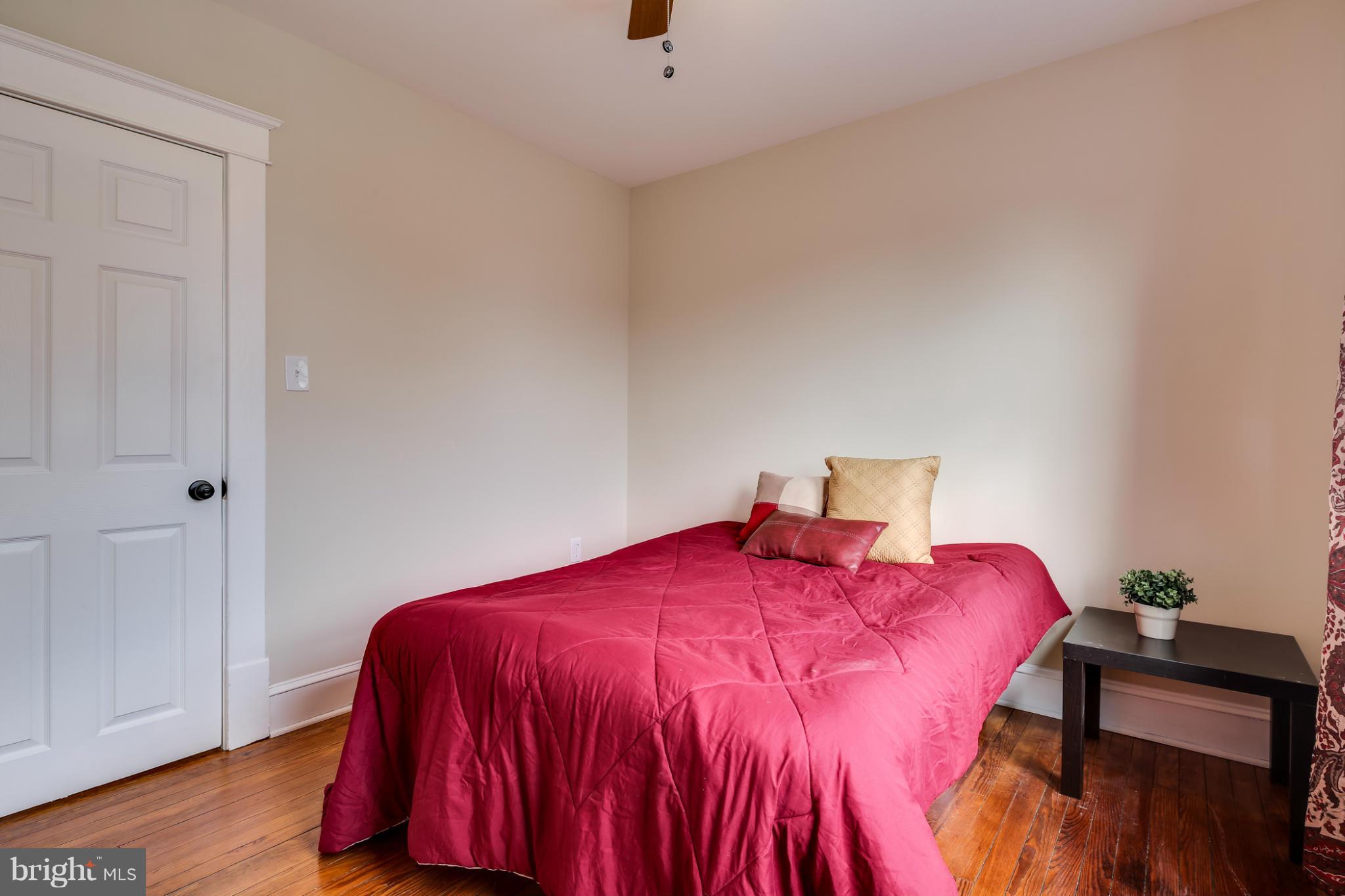 3202 Grace Road Baltimore, MD 21219 - Photo 19 of 29 a bedroom with a bed and a lamp