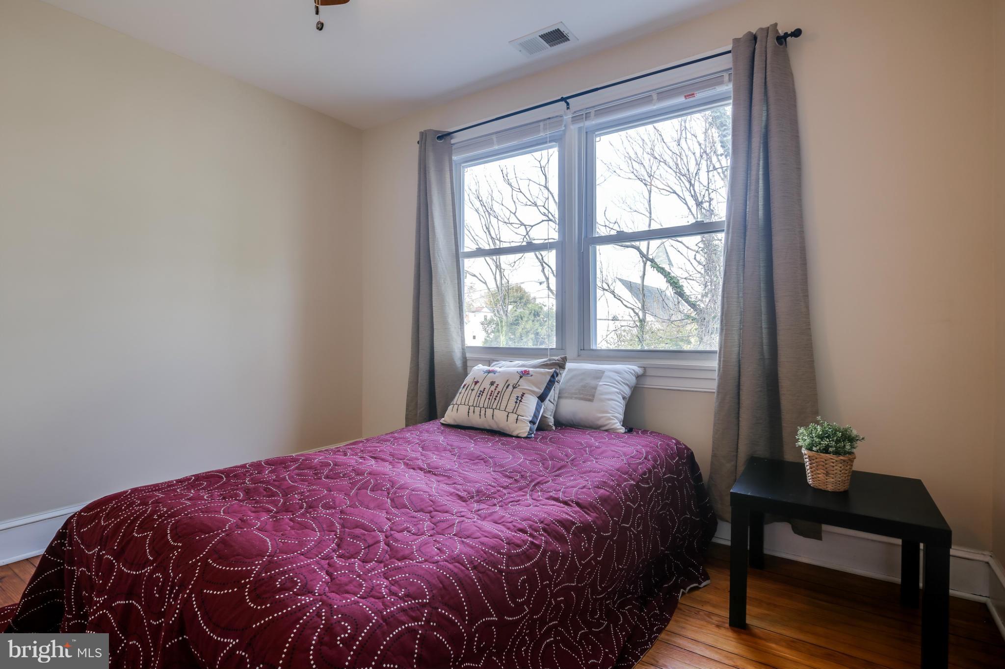 3202 Grace Road Baltimore, MD 21219 - Photo 21 of 29 a large bed sitting in a bedroom next to a window