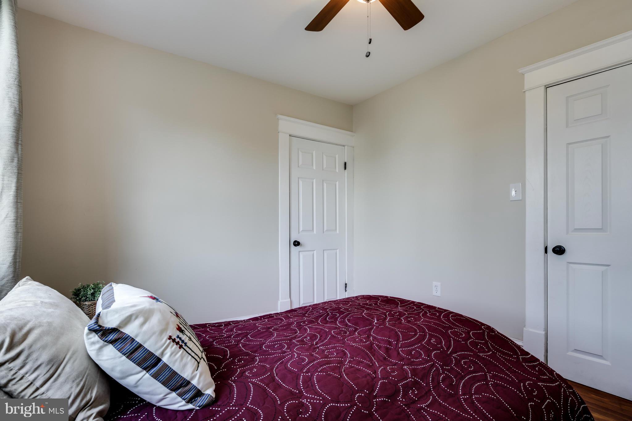 3202 Grace Road Baltimore, MD 21219 - Photo 22 of 29 a bedroom with a bed and a chandelier