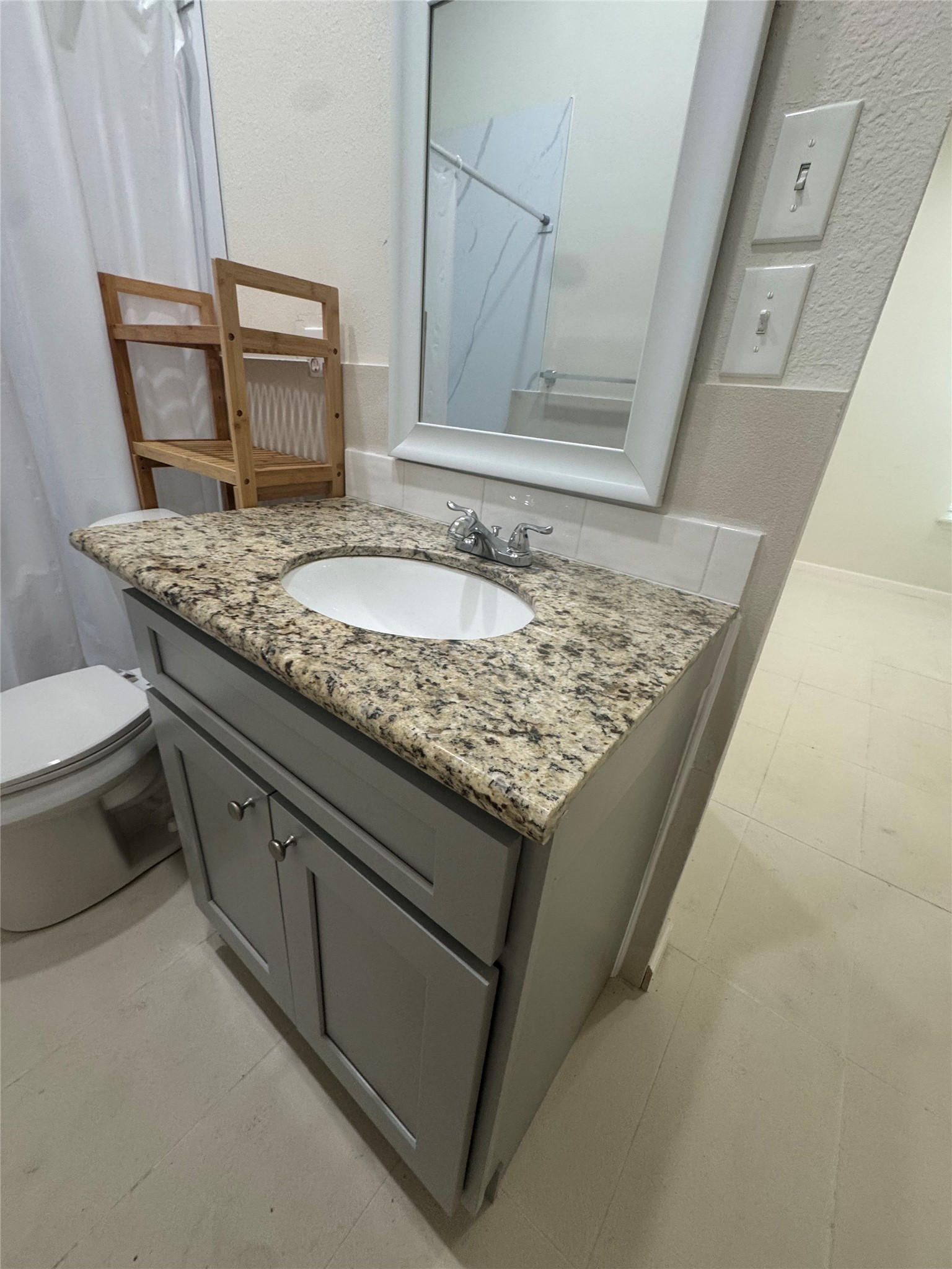 1443 Willow Rock Road Houston, TX 77088 - Photo 17 of 27 a bathroom with a granite countertop sink and a mirror