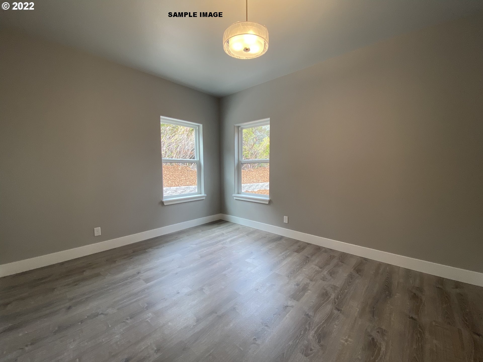 1800 Dunbar Way Florence, OR 97439 - Photo 17 of 32 an empty room with wooden floor and a window