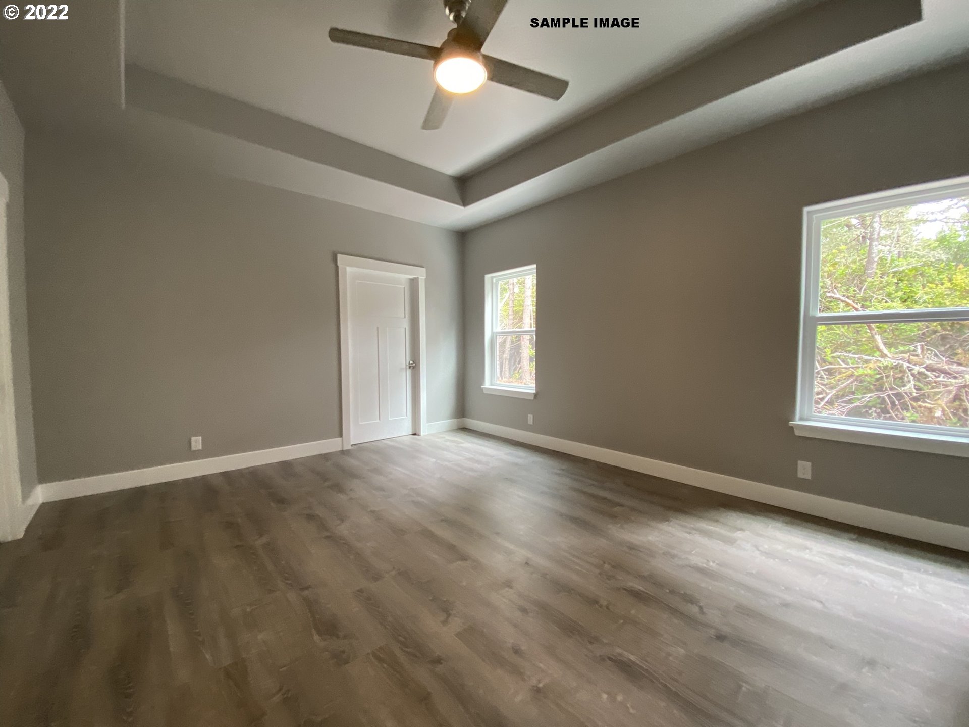1800 Dunbar Way Florence, OR 97439 - Photo 18 of 32 an empty room with wooden floor and windows