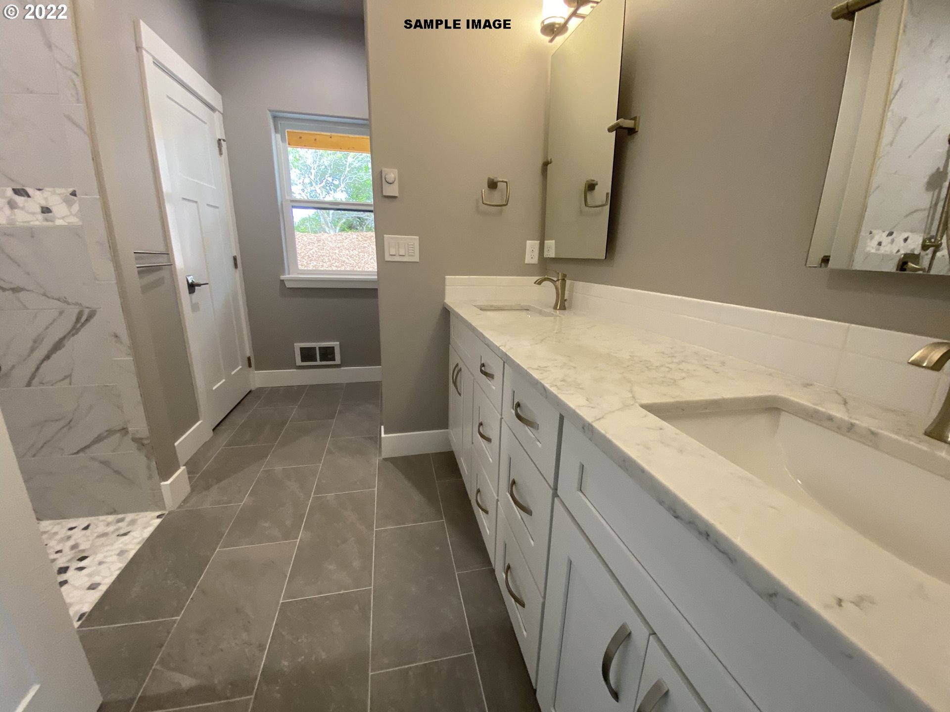 1800 Dunbar Way Florence, OR 97439 - Photo 22 of 32 a spacious bathroom with a granite countertop sink a mirror and a bathtub