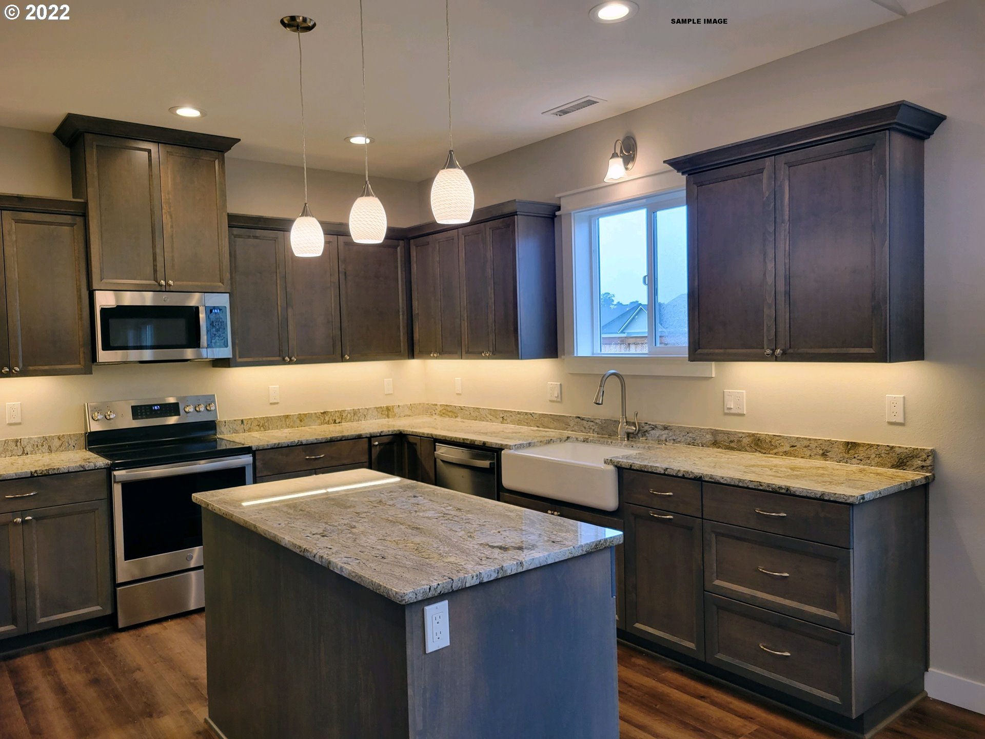 1800 Dunbar Way Florence, OR 97439 - Photo 6 of 32 a kitchen with a sink and a stove top oven with wooden floor