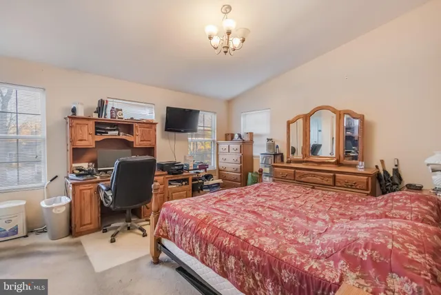 a bed room with a bed and a television