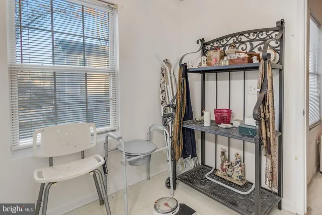 a living room with furniture a rug and a large window
