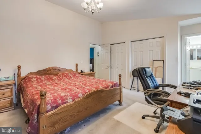 a bedroom with a bed and lamp