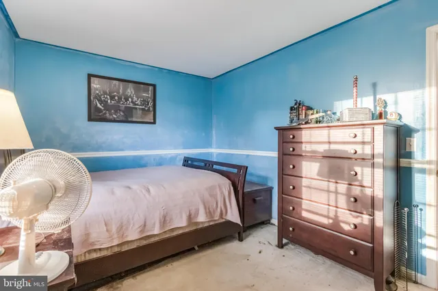 a bedroom with a large bed and a fireplace