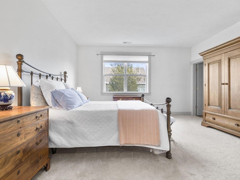 34 Lantern Way, Unit 34 Ashland, MA 01721 - Photo 14 of 30 a bed sitting in a bedroom next to a window