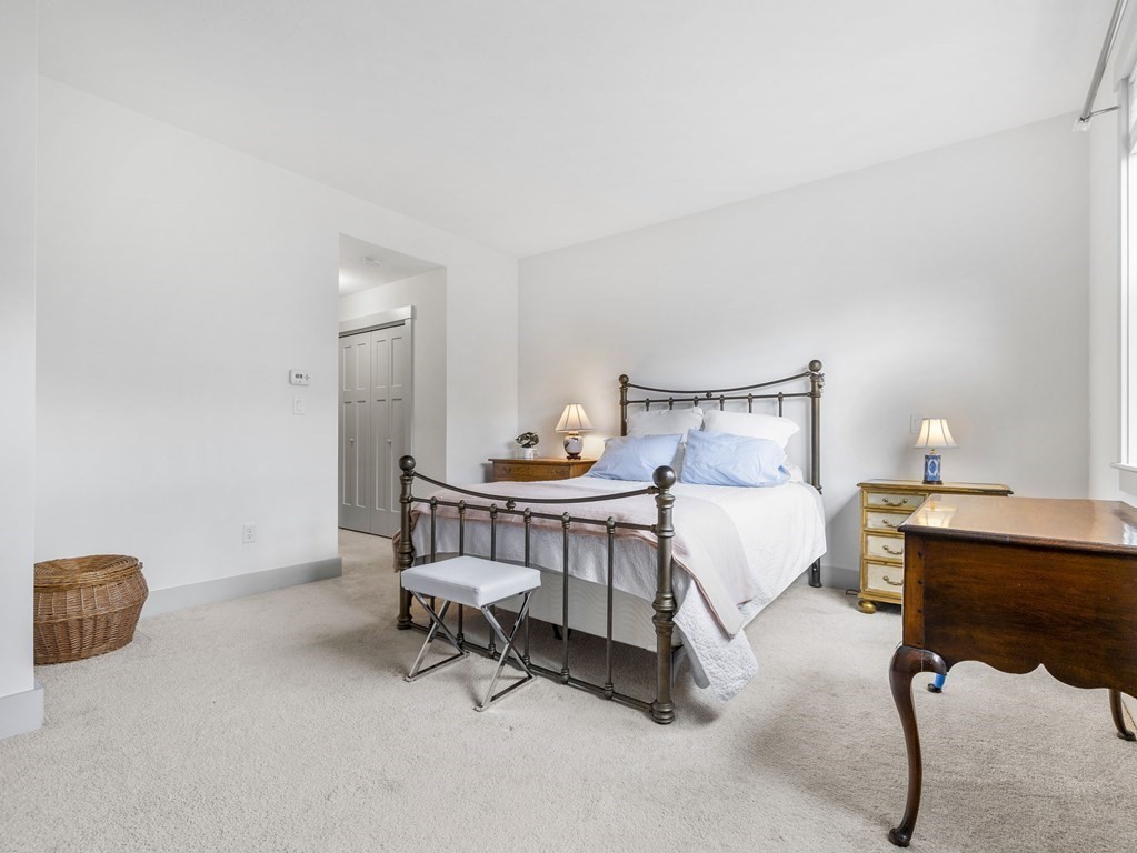 34 Lantern Way, Unit 34 Ashland, MA 01721 - Photo 15 of 30 a bed room with a bed and a table