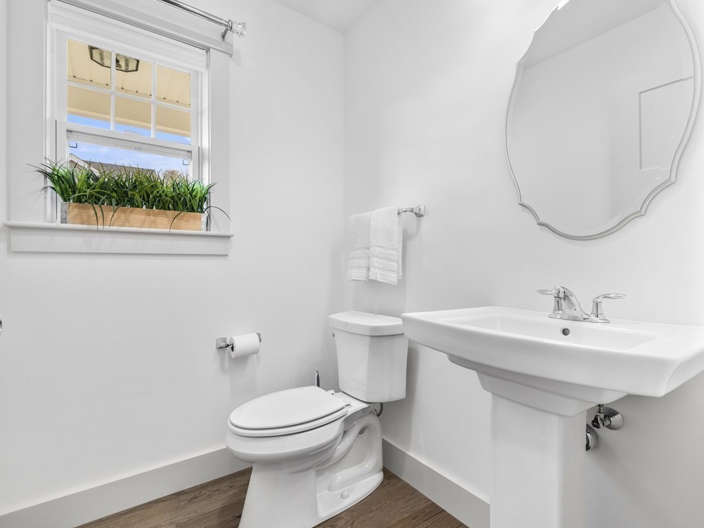 34 Lantern Way, Unit 34 Ashland, MA 01721 - Photo 18 of 30 a bathroom with a sink a mirror a toilet and a window