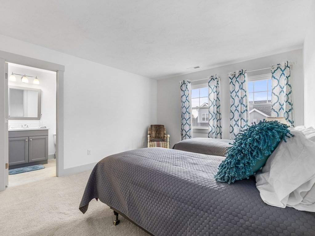 34 Lantern Way, Unit 34 Ashland, MA 01721 - Photo 22 of 30 a bedroom with a large bed and a potted plant