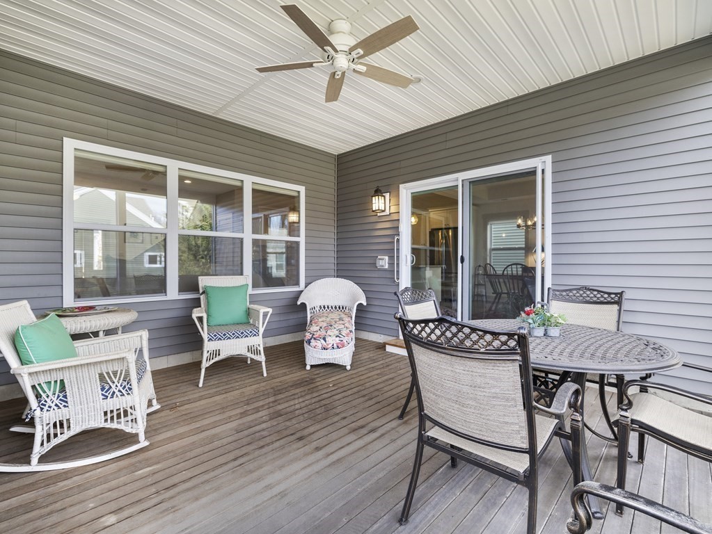 34 Lantern Way, Unit 34 Ashland, MA 01721 - Photo 24 of 30 a view of a deck with table and chairs and wooden floor
