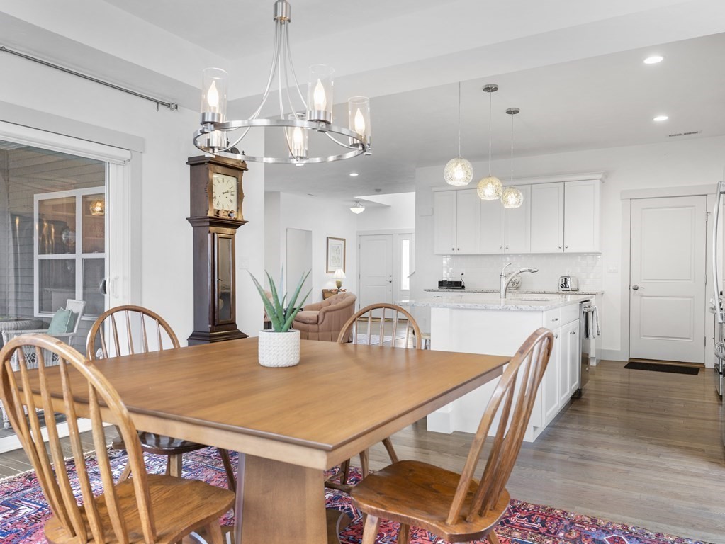 34 Lantern Way, Unit 34 Ashland, MA 01721 - Photo 7 of 30 a kitchen with stainless steel appliances a table chairs and chandelier