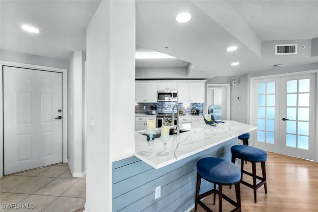a kitchen with stainless steel appliances granite countertop counter space and a refrigerator
