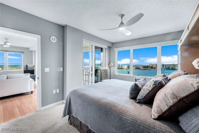 a bedroom with a large bed and a large window