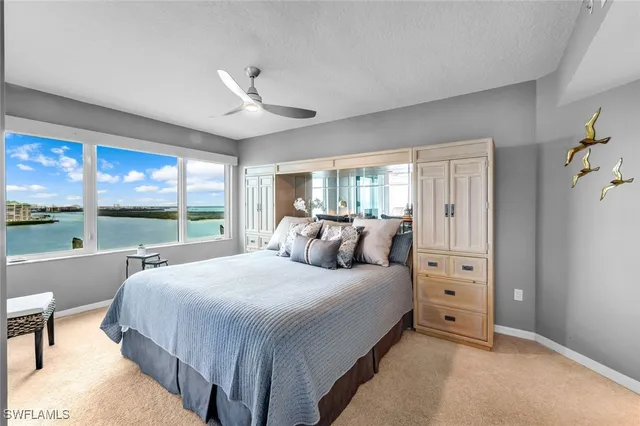 a bedroom with a large bed and a large window