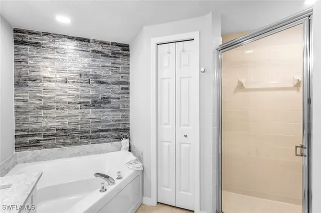 a bathroom with a bathtub and a shower