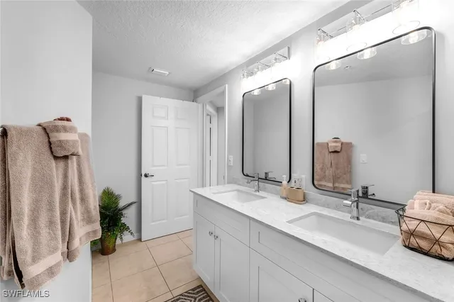 a bathroom with a double vanity sink and a mirror