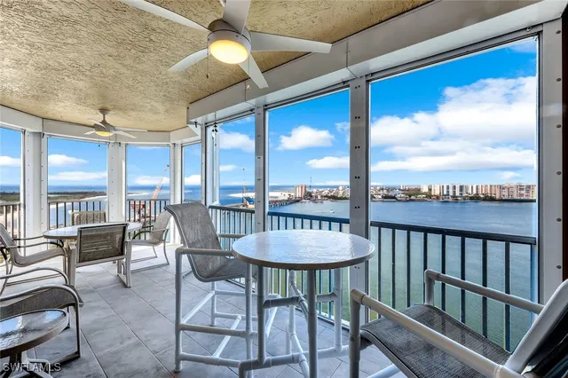 a view of a dining room with furniture large windows and wooden floor