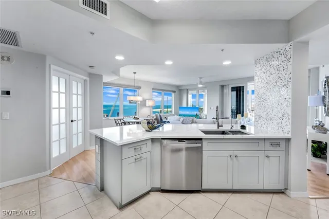 a kitchen with a sink window and cabinets