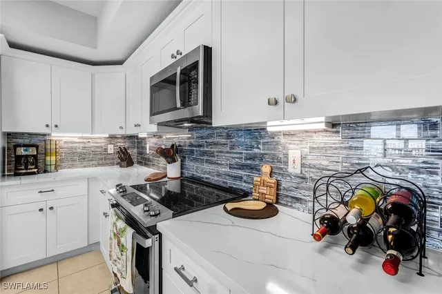 a kitchen with a stove a sink and a microwave