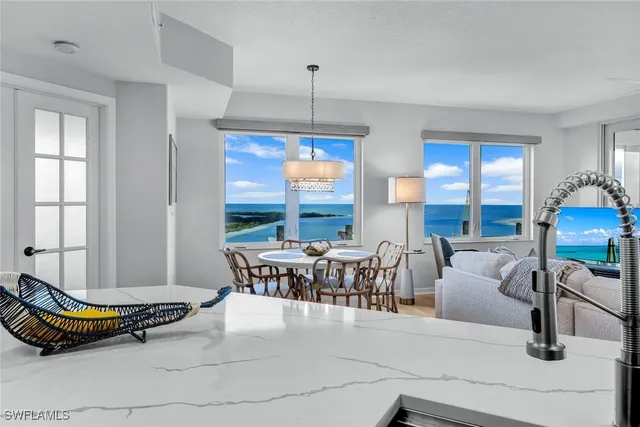 a living room with furniture two window and a table