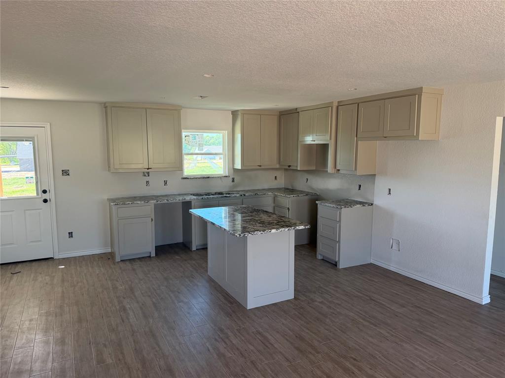 312 Myers Drive Springtown, TX 76082 - Photo 2 of 6 a kitchen with a sink window and cabinets