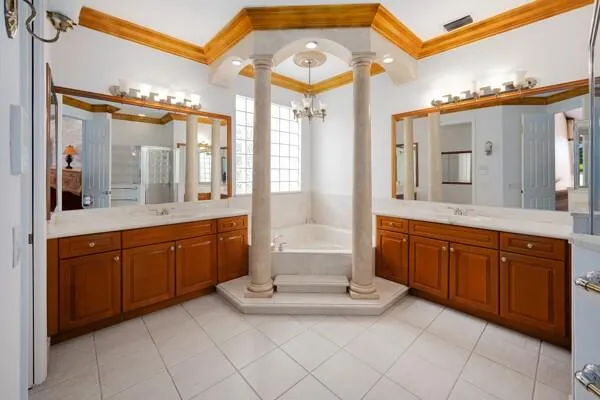 a view of a hallway with wooden floor and a bathroom