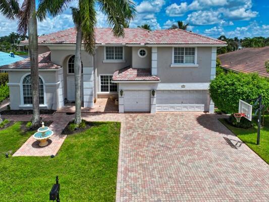 576 Northwest 120th Drive Coral Springs, FL 33071 - Photo 23 of 23 front view of a house with a yard and potted plants