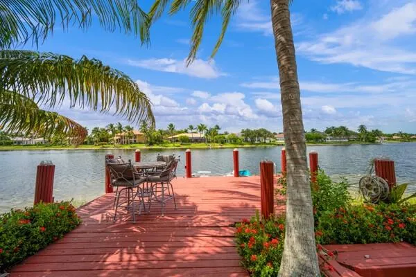 a view of a lake with a table and chairs