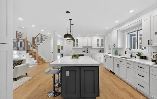 a kitchen with counter top space a sink stainless steel appliances and cabinets