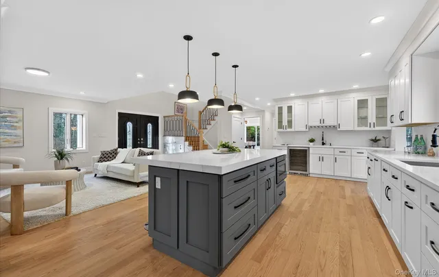 a kitchen with kitchen island granite countertop a sink counter top space and stainless steel appliances