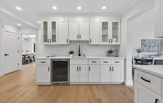 a kitchen with stainless steel appliances granite countertop a stove a sink and white cabinets