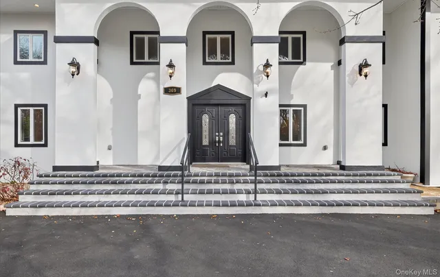 a view of a brick house with large windows
