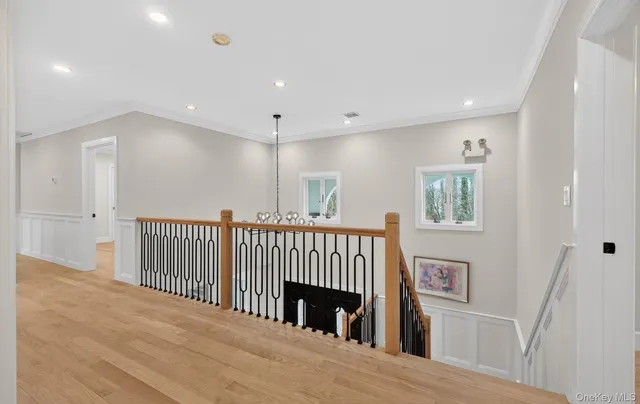 a view of a hallway with windows and stairs