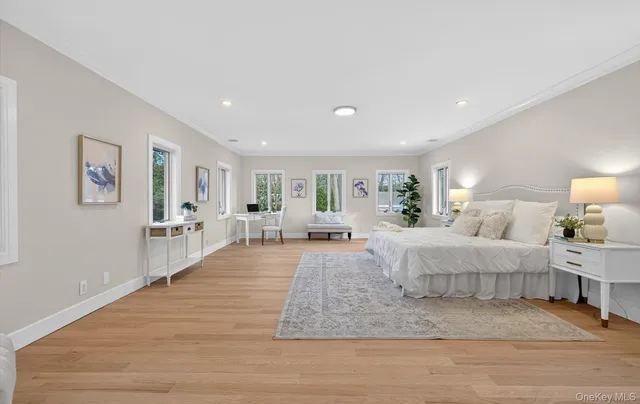 a living room with furniture and a large mirror with wooden floor