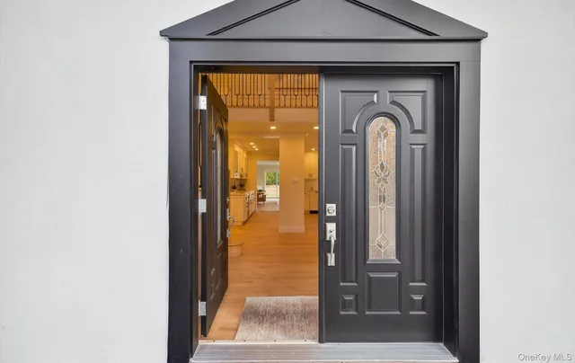 a view of a hallway with a door and a door