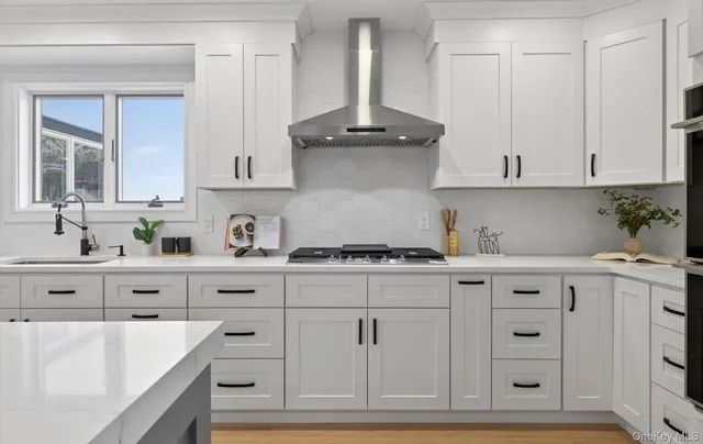 a kitchen with granite countertop white cabinets and white appliances