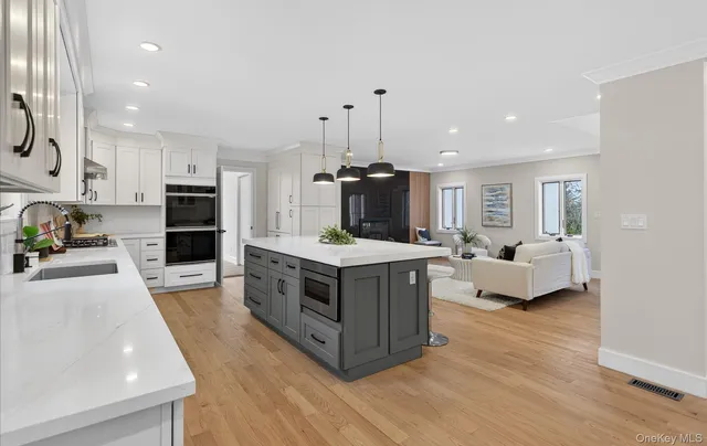 a kitchen with stainless steel appliances a sink dishwasher stove top oven and refrigerator