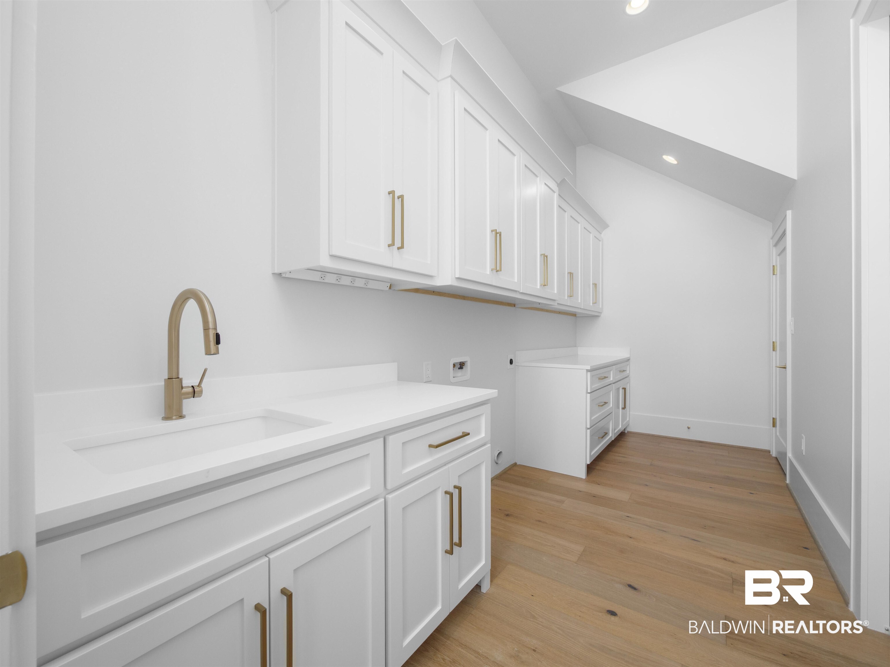 31292 River Road Orange Beach, AL 36561 - Photo 27 of 48 Laundry room with cabinet space, hookup for a washing machine, hookup for an electric dryer, light wood-style floors, and a sink