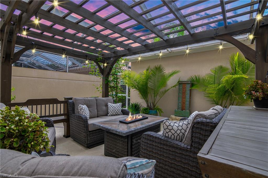 a view of a patio with couches table and chairs and potted plants
