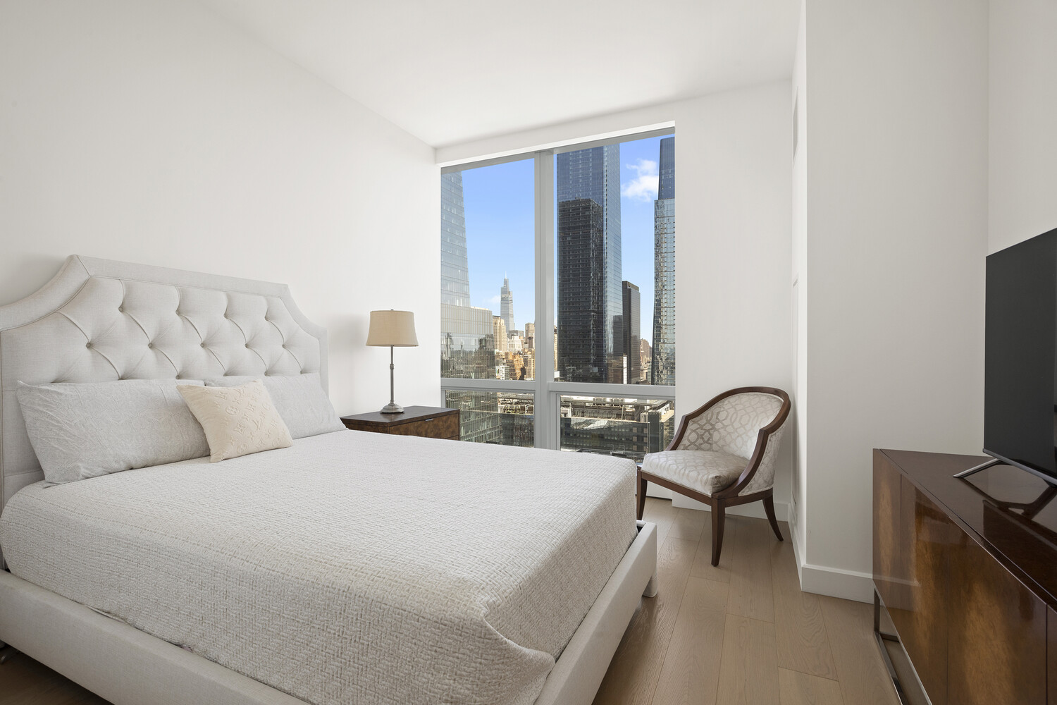 15 Hudson Yards, Unit 33H Manhattan, NY 10001 - Photo 2 of 10 a bedroom with a bed and a flat screen tv